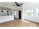 Bright and airy living room featuring wood floors, ceiling fan, and an open view into the kitchen at 1316 Barry St, Clearwater, FL 33756