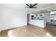 Bright and airy living room featuring wood floors, open layout and views into the kitchen at 1316 Barry St, Clearwater, FL 33756