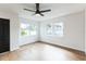 Bright living room features hardwood floors, a ceiling fan, and natural light at 1316 Barry St, Clearwater, FL 33756