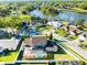 Serene aerial view of a beautiful neighborhood with a pool, surrounded by lush greenery and a tranquil lake at 1375 Corner Oaks Dr, Brandon, FL 33510