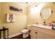 Charming half-bathroom featuring a stylish vanity with granite countertop and cute whale-themed decoration at 1375 Corner Oaks Dr, Brandon, FL 33510