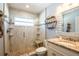 Beautiful bathroom features a glass shower, granite counters, stylish shelving, and attractive tile at 1375 Corner Oaks Dr, Brandon, FL 33510