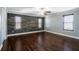 Spacious bedroom featuring a stone accent wall, hardwood flooring, and natural light at 1375 Corner Oaks Dr, Brandon, FL 33510