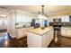 Well-appointed kitchen with a central island, stainless steel appliances, granite countertops, and updated cabinetry at 1375 Corner Oaks Dr, Brandon, FL 33510