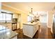 Open kitchen features a spacious island, granite countertops, stainless steel appliances, and hardwood flooring at 1375 Corner Oaks Dr, Brandon, FL 33510