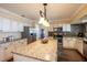 Spacious kitchen features an island, granite countertops, stainless steel appliances, and ample cabinet space at 1375 Corner Oaks Dr, Brandon, FL 33510
