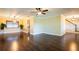 Open living room with ceiling fan, hardwood floors, and staircase access at 1375 Corner Oaks Dr, Brandon, FL 33510