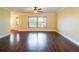 Bright living room with beautiful dark hardwood flooring, ceiling fan, and large window at 1375 Corner Oaks Dr, Brandon, FL 33510