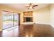Living room featuring hardwood floors, brick fireplace, and sliding glass doors at 1375 Corner Oaks Dr, Brandon, FL 33510