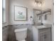 Bathroom showcases modern toilet, stylish vanity with granite countertop, and decorative art at 1415 54Th N Ave, St Petersburg, FL 33703