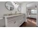 Bright bathroom boasts granite countertop, dual sinks, framed mirrors, and opens to bedroom at 1415 54Th N Ave, St Petersburg, FL 33703