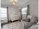 Bedroom with sailboat wallpaper, white crib, comfortable armchair and rug at 1415 54Th N Ave, St Petersburg, FL 33703