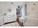 Bright Bedroom showcases ample closet space, white dresser and crib, and nautical wallpaper at 1415 54Th N Ave, St Petersburg, FL 33703
