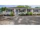 Charming home featuring a landscaped front yard and a light blue front door at 1415 54Th N Ave, St Petersburg, FL 33703