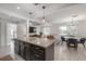Open concept kitchen with island, stainless appliances, and view to living and dining area at 1415 54Th N Ave, St Petersburg, FL 33703