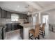 Open kitchen featuring granite counters, pendant lights, modern appliances and seating area with 2 wicker chairs at 1415 54Th N Ave, St Petersburg, FL 33703