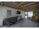Enclosed patio space featuring string lights, a wall-mounted television and access to backyard at 1415 54Th N Ave, St Petersburg, FL 33703