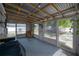 Bright sunroom with rustic walls and metal roof at 1415 54Th N Ave, St Petersburg, FL 33703