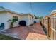 Spacious backyard with concrete area, white exterior, and a wooden fence creating a private outdoor space at 1436 Temple St, Clearwater, FL 33756