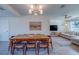 Inviting dining room adjacent to living area, featuring a large dining table with modern decor at 1436 Temple St, Clearwater, FL 33756