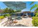 Enjoy a private backyard oasis with a sparkling pool, hot tub, and outdoor dining area at 1596 Belleair Ln, Clearwater, FL 33764