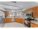 Bright kitchen featuring stainless steel appliances, wood cabinets, and a view of the backyard at 16015 Glen Haven Dr, Tampa, FL 33618