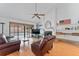 Cozy living room with a fireplace, built-in shelving, wood floors, and a view of the pool at 16015 Glen Haven Dr, Tampa, FL 33618