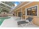 Outdoor pool with a screened enclosure, lounge area, grill, and a shed in the background at 16015 Glen Haven Dr, Tampa, FL 33618