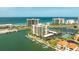 Aerial view of the condo building near the ocean with a marina at 1651 Sand Key Estates Ct # 53, Clearwater, FL 33767