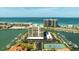 Beautiful aerial view of waterfront condo community with boat docks and beach access at 1651 Sand Key Estates Ct # 53, Clearwater, FL 33767
