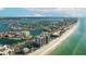 Aerial view of beachfront condos with boat docks, tennis courts, and beach views at 1651 Sand Key Estates Ct # 53, Clearwater, FL 33767