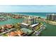 Aerial view of the waterfront condo building, with marina, tennis courts, and ocean in the background at 1651 Sand Key Estates Ct # 53, Clearwater, FL 33767