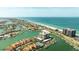 Expansive aerial shot showcasing the beachfront condo, coastal homes, and marina at 1651 Sand Key Estates Ct # 53, Clearwater, FL 33767