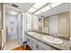 Well-lit bathroom features double sinks, granite countertops, and decorative accents at 1651 Sand Key Estates Ct # 53, Clearwater, FL 33767