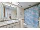 Bathroom featuring a granite countertop vanity, toilet, and a shower with seashell patterned curtain at 1651 Sand Key Estates Ct # 53, Clearwater, FL 33767