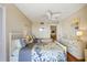 Charming bedroom featuring two twin beds, a ceiling fan, and bright decor at 1651 Sand Key Estates Ct # 53, Clearwater, FL 33767