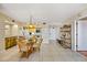 Dining area next to kitchen featuring a round table, four woven chairs, and decorative overhead lighting, highlighting kitchen elements at 1651 Sand Key Estates Ct # 53, Clearwater, FL 33767