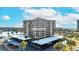 Condo exterior view with covered parking, palm trees, and easy access to waterfront activities at 1651 Sand Key Estates Ct # 53, Clearwater, FL 33767