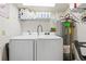 Convenient laundry room includes washer, dryer and storage shelves at 1651 Sand Key Estates Ct # 53, Clearwater, FL 33767