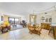 Bright living room with tile flooring, neutral decor, and a dining area, showcasing an open-concept design and a waterfront view at 1651 Sand Key Estates Ct # 53, Clearwater, FL 33767