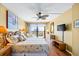 Bedroom with wood floors, ceiling fan, balcony, and ocean view at 1651 Sand Key Estates Ct # 53, Clearwater, FL 33767