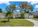 Charming single-story home with a well-kept lawn and a driveway leading to a single car garage at 1661 Grove St, Clearwater, FL 33755