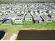 Aerial view showcases the property's green lawn, and lake, nestled in a neighborhood at 17802 Everlong Dr, Land O Lakes, FL 34638