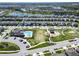 Aerial view of the community showcasing the clubhouse, swimming pool, playground, and neighborhood homes at 17802 Everlong Dr, Land O Lakes, FL 34638