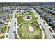 Aerial view of the community showcasing the clubhouse, swimming pool, playground, and neighborhood homes at 17802 Everlong Dr, Land O Lakes, FL 34638