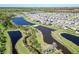 High angle picture of a house with solar panels with a nearby lake in a thriving community at 17802 Everlong Dr, Land O Lakes, FL 34638