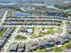 An aerial view of a neighborhood, showcasing a home near a lake, recreational area and community amenities at 17802 Everlong Dr, Land O Lakes, FL 34638