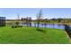 Fenced backyard with lush green lawn and serene water views, providing a peaceful outdoor setting at 17802 Everlong Dr, Land O Lakes, FL 34638