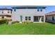 Spacious backyard featuring lush green lawn, a covered patio, and plenty of room for outdoor activities and entertainment at 17802 Everlong Dr, Land O Lakes, FL 34638