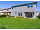 Expansive backyard featuring lush green lawn, a covered patio, and ample space for outdoor activities and entertaining at 17802 Everlong Dr, Land O Lakes, FL 34638